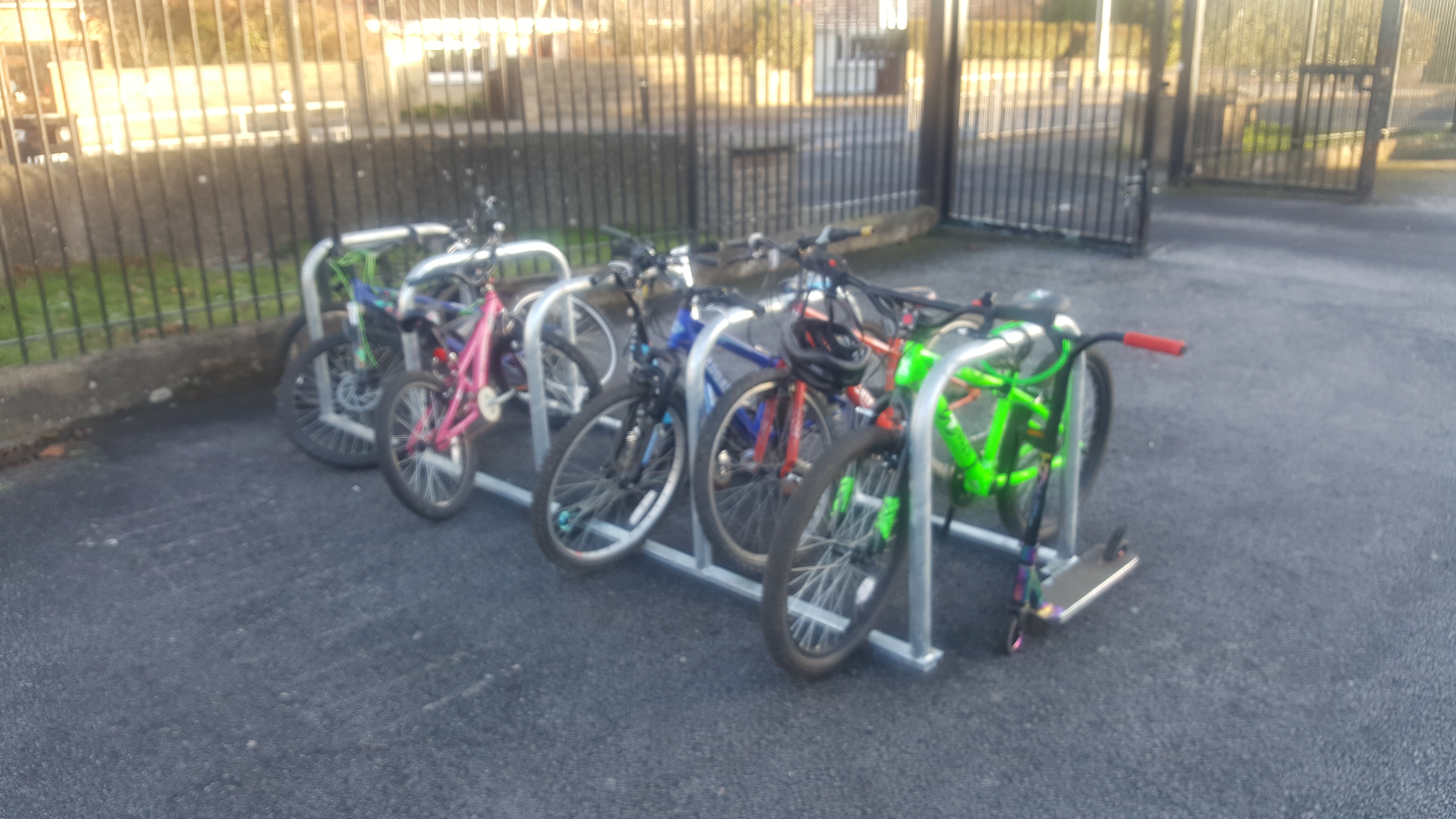 This photo shows a cycle rack with five stands in a school yard.